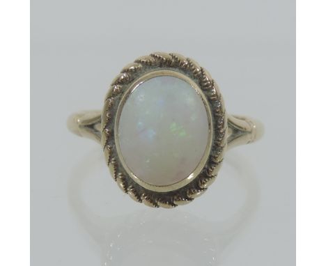 A 9 carat gold and opal ring, boxed