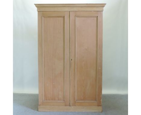 A Victorian pine double wardrobe, fitted with shelves, 130cm