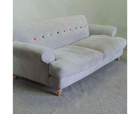 A contemporary grey upholstered two seater sofa, on turned legs, 200cm