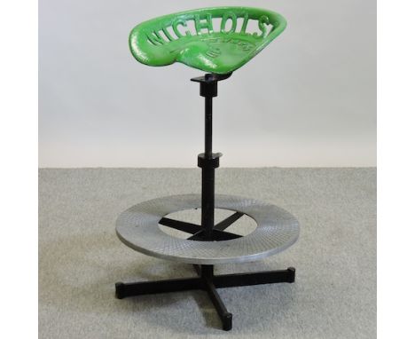 A green painted metal tractor seat stool