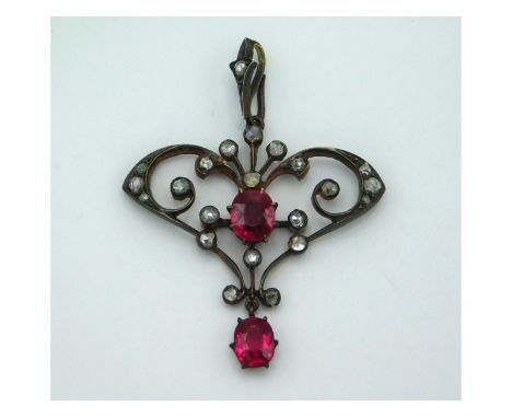 A yellow metal Edwardian pendant set with diamond & ruby which each measure 6.5mm x 5mm, 44mm drop, 4.4g