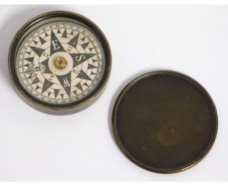 An early 20thC. brass pocket compass, 60mm diameter