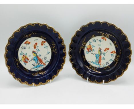 A pair of first period 18thC. Worcester porcelain dishes with scalloped rim, decorated with exotic bird on white panel with g