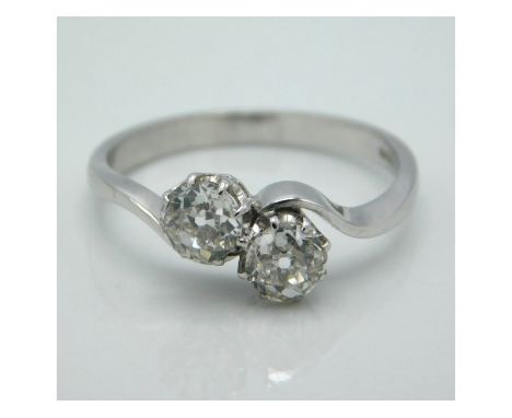 An 18ct white gold crossover ring set with two old cut diamonds of approx. 0.8ct, 2.8g, size N