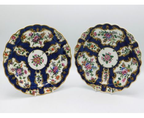 A pair of first period 18thC. Worcester porcelain dishes with scalloped rim, decorated with floral sprays on cobalt & white g