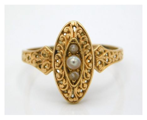 An antique yellow metal ring with carved decor, set with pearl, tests electronically as 18ct gold, 1.9g, size P/Q