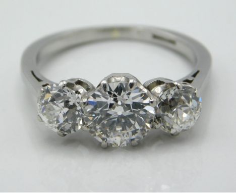 An antique platinum 2.5ct diamond trilogy ring set with lively stones, centre 1.5ct with 0.5ct either side, one smaller stone