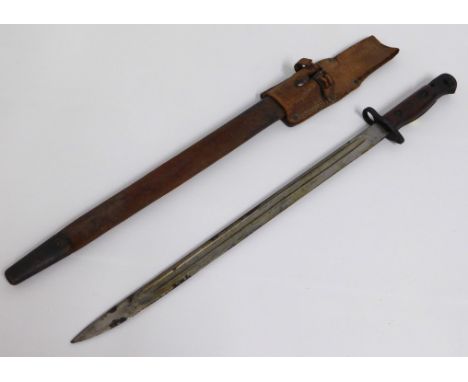 An early 20thC. bayonet with scabbard & leather belt attachment, 572mm long