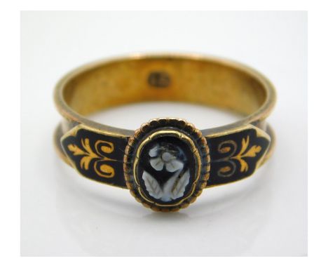 A 19thC. 15ct gold mourning ring with black enamelling & hardstone carving, small loss to petals, 2.3g, size N 