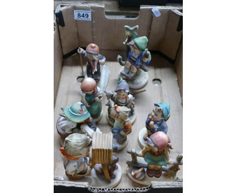 A collection of Goebel Hummel figures to include boy with camera, Just resting, Boy with rabbits, Young girl with watering ca