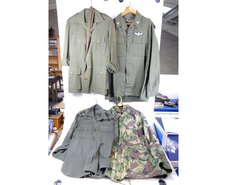 A collection of Army uniform items to inlcude shirts and camoflage jacket (4)