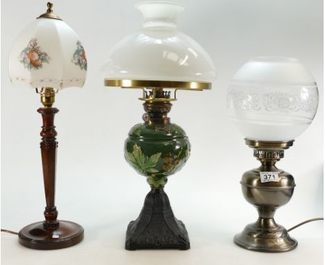 Early 20th century embossed pottery oil lamp with glass shade and two other lamps with glass shades (3)