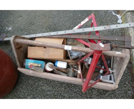 A collection of tools to include clamps, drill bits, hinges, hammers etc in a vintage tool box