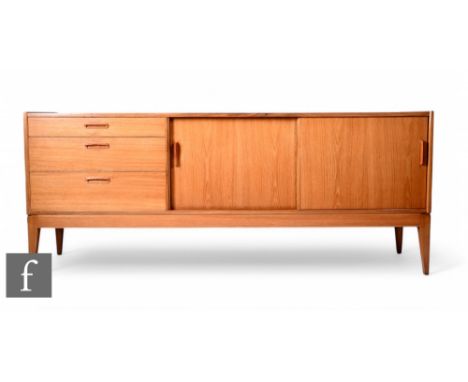 Alfred Cox - A 1960s teak sideboard, fitted with a bank of three drawers beside a sliding double door cupboard, raised to spl
