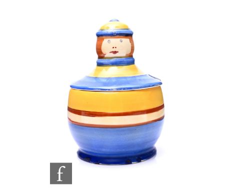 Clarice Cliff - A figural preserve and cover of footed ovoid form with a figural head wearing a hat as the finial in blue, br