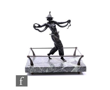 Unattributed Maker - A 1930s Art Deco bronze figure of a female snake charmer in exotic costume with a snake wrapped around h