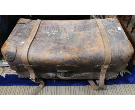 A large leather twin handled travelling trunk, with two straps &amp; lock