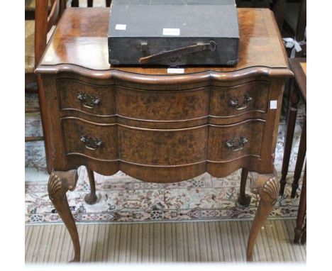 A reproduction burr walnut serpentine fronted chest of two drawers raised upon shell carved cabriole legs, 73cm high Conditio