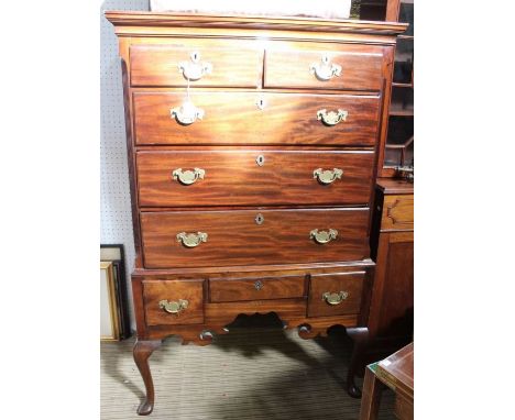 19th century mahogany five draw chest on stand, the base having three drawers, over fancy carved apron over four cabriole leg
