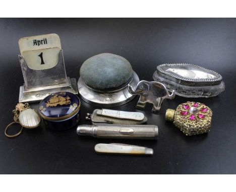 A collection of various decorative wares, includes; a silver mounted desk calendar, a silver based pin cushion, two mother-of