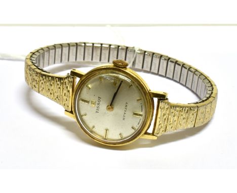 TISSOT, A LADY'S SWISS 18CT GOLD ROUND WRIST WATCH silvered dial with raised gilt baton numerals and hands, 21mm round two pi