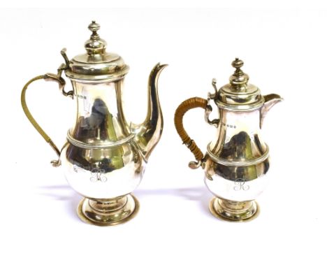 A SILVER BALUSTER SHAPED COFFEE POT AND HOT MILK JUG IN GEORGE I STYLE each with a domed cover with a knop finial, a moulded 