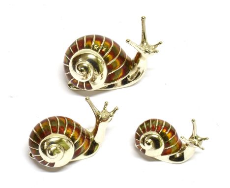 A SET OF THREE GRADUATED SILVER AND ENAMEL SNAILS each modelled with antennae raised, the shells decorated in shades of brown