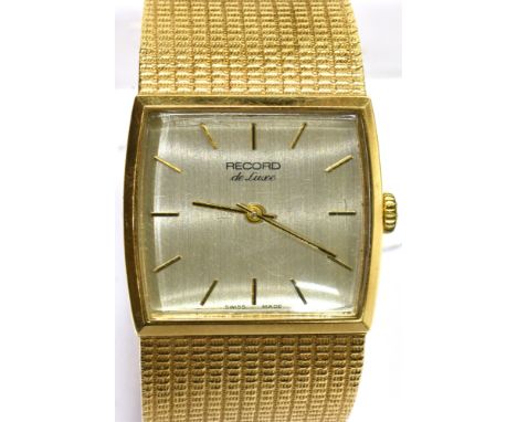 RECORD, DE LUX, A GENTLEMAN'S 9CT GOLD TONNEAU-SHAPED INTEGRAL BRACELET WATCH, CIRCA 1978 brushed silvered dial with raised b