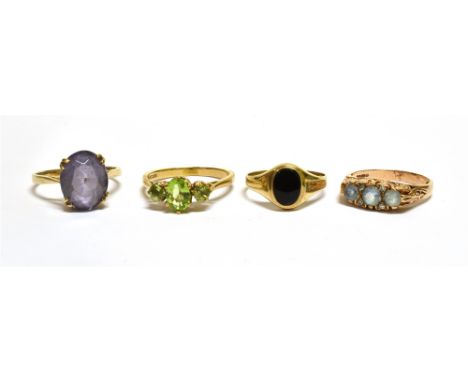 A GROUP OF FOUR GOLD AND GEM SET RINGS INCLUDING A 9CT GOLD AND AQUAMARINE THREE STONE CARVED HALF-HOOP RING  with rose diamo