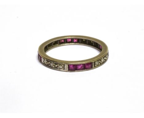 A MID-20TH CENTURY RUBY AND DIAMOND ETERNITY RING  alternately grain set in white with groups of three small eight-cut diamon
