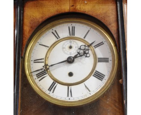 A CONTINENTAL WALL CLOCK  the enamel dial with Roman numerals and subsidiary seconds dial, weight driven movement, in a walnu