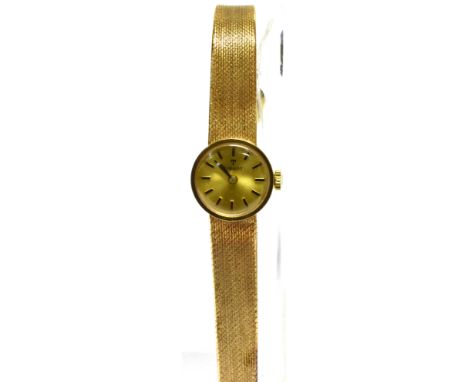 TISSOT, A LADY'S 9CT GOLD ROUND BRACELET WATCH, CIRCA 1974 brushed golden dial with raised black baton numerals and hands, tw