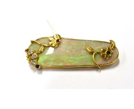 A MODERN 18CT GOLD, OPAL, RUBY, EMERALD AND DIAMOND BROOCH BY ERICA SHARPE  the 5cm (2 in) elongated-oblong white opal displa