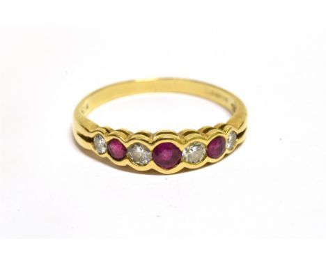 A MODERN 18CT GOLD, RUBY AND DIAMOND SEVEN STONE RING  the four graduated round brilliant diamonds approx. 0.25cts total spac