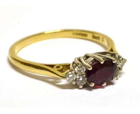 A MODERN 18CT GOLD, RUBY AND DIAMOND DRESS RING  centred with an oval native-cut ruby approx. 0.91cts, between small round br