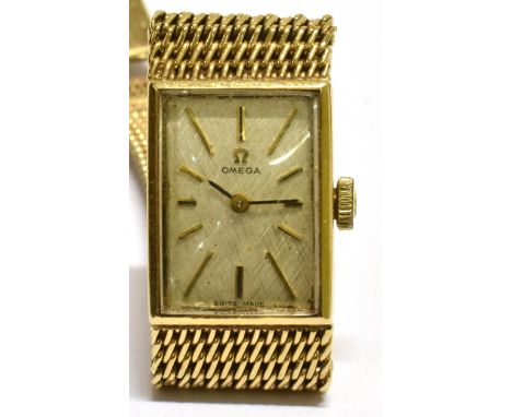 OMEGA, A LADY'S 9CT GOLD RECTANGULAR BRACELET WATCH, CIRCA 1969 brushed-silvered dial with raised gilt baton numerals and han