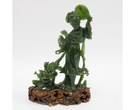 Spinach green jade carving of a woman with a fan and flowers, on wooden stand, 22cm. 