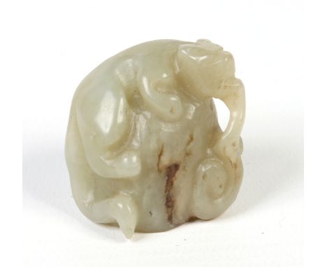 A small Chinese celadon jade carving of a leopard clambering upon a rock, 3.25cm.  Condition Report. To be used as a guide on