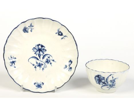 A Worcester fluted tea bowl and saucer. Painted in underglaze blue with the gilliflower pattern. Script W mark c1770. Conditi