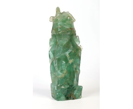 A large Chinese carved green fluorite vase and cover of hexagonal form. Decorated in relief with figures, trailing flowers an