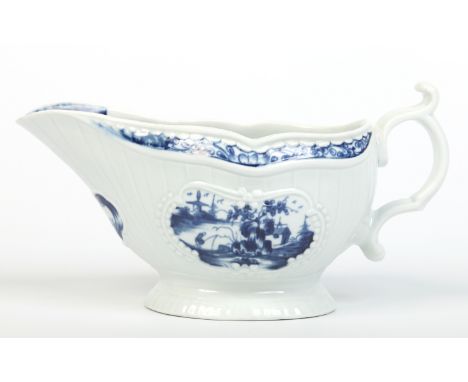 A Worcester strap fluted sauceboat with scrolling handle. Painted in underglaze blue with the Fisherman and Billboard Island 