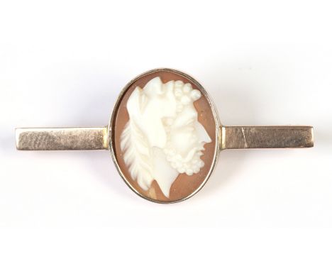 A boxed 19th century yellow metal bar brooch set with an ovoid cameo portrait of a Masquerader, 4.5cm.  Condition Report. To 