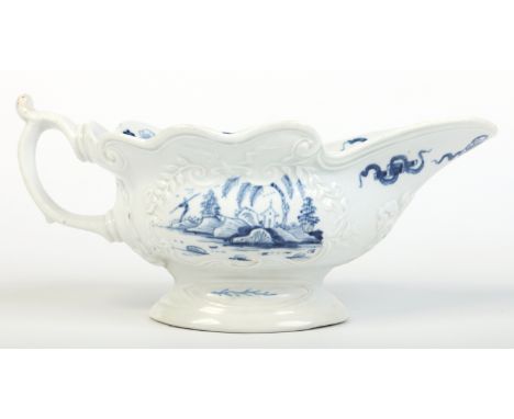 A rare Worcester silver shaped sauceboat with moulded cartouches and scrolling handle with upturned thumb rest. Painted in un
