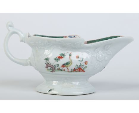 A Worcester silver shaped sauceboat. Moulded with cartouches of trailing flowers and ribbon swags to the foot. Decorated in t