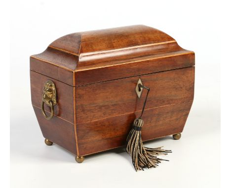 A Regency mahogany dome top tea caddy. With strung inlay, ivory escutcheon, brass lion mask handles and raised on brass ball 