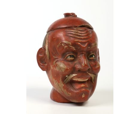 An early 20th century Japanese lacquered novelty tea caddy in the form of a mans head, 16cm.  Condition Report. To be used as