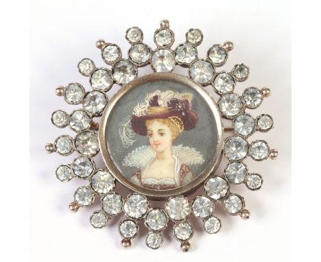 A 19th century French gold sunburst brooch set with European cut white paste stones and a central portrait miniature of a you