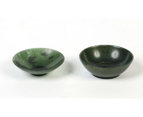 Two Chinese small mottled spinach jade bowls. Largest 7cm diameter.  Condition Report. To be used as a guide only. Larger bow