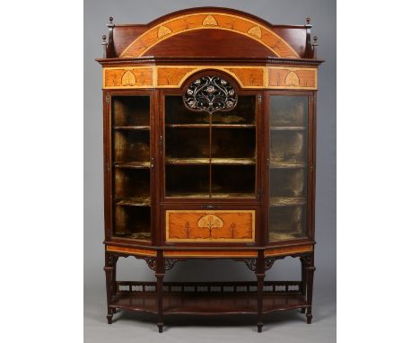 A large Art Nouveau mahogany display cabinet. With arch top pediment and stylized marquetry tulips on satinwood grounds. With