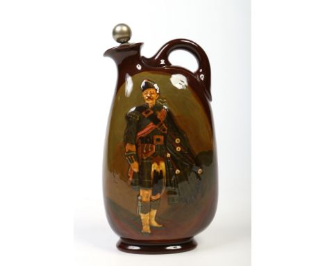 A Royal Doulton Kingsware Dewars Whisky flagon with named white metal stopper. Decorated in brown glaze and with a portrait o